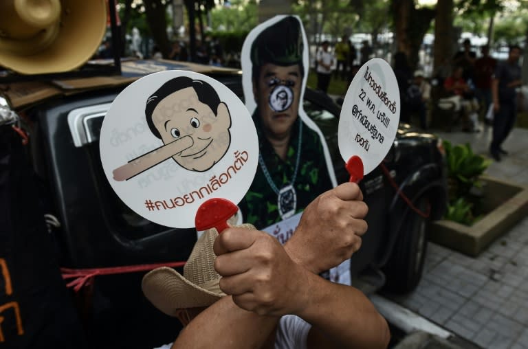 Demonstrators display cartoons portraying Thai Prime Minister Prayut Chan-O-Cha as Pinocchio during a protest at Thammasat University in Bangkok