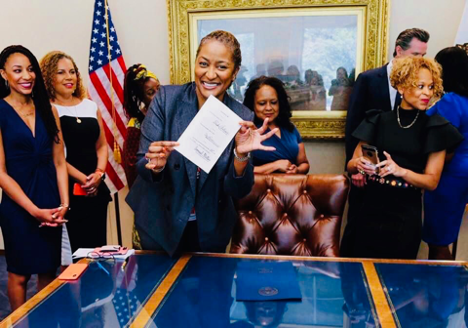 Senator Holly J. Mitchell celebrates Gov. Cavin Newsom signing the CROWN Act on July 3, 2019, making California the first state to pass the bill. (Photo: JOY Collective)