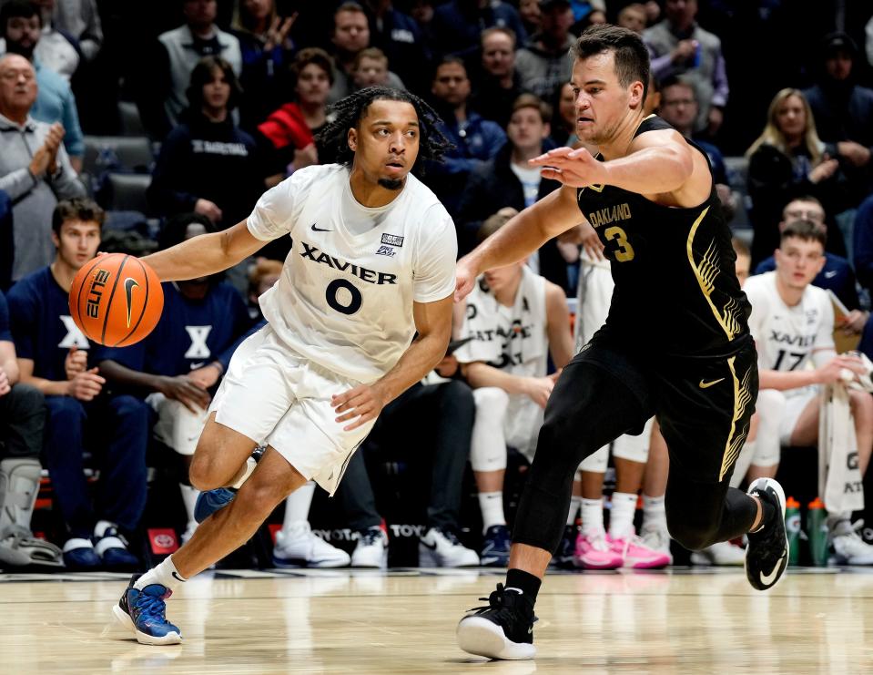 Xavier Musketeers guard Trey Green (0) drives around Oakland Golden Grizzlies guard Jack Gohlke (3) Monday, November 27, 2023 at the Cintas Center.