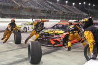 Martin Truex Jr. makes a pit stop during the NASCAR Cup Series auto race Wednesday, May 20, 2020, in Darlington, S.C. (AP Photo/Brynn Anderson)