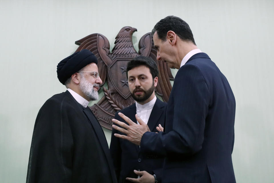 Syrian President Bashar Assad, right, speaks with Iranian President Ebrahim Raisi, left, in Damascus, Syria, Wednesday, May 3, 2023. Raisi Wednesday met Assad in Damascus in a bid to boost cooperation between the two allies, state media reported. (AP Photo/Omar Sanadiki)