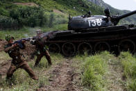 North Korean soldiers from the historic 105 tank unit fire during a military exercise at an undisclosed location in North Korea Friday, July 27, 2012, marking the 59th anniversary of the armistice that ended the 1950-53 Korean War. The 105 tank unit, which denounced joint U.S. and South Korean military exercises, is named after North Korean military officer Ryu Kyong Su, honored by North Korea for his role leading troops during the Korean War. (AP Photo/Jon Chol Jin)