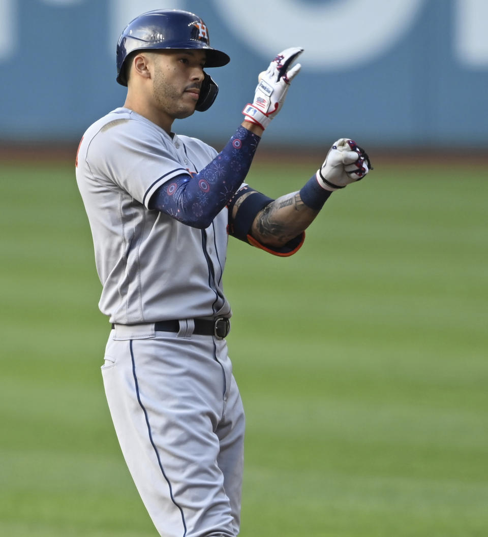 Houston Astros' Carlos Correa (1) celebrates after hitting an RBI-single in the first inning of a baseball game against the Cleveland Indians, July 3, 2021, in Cleveland. (AP Photo/David Dermer)