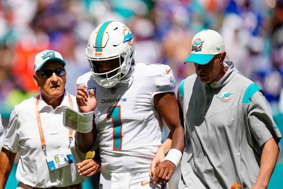 Quarterback Tua Tagovailoa is helped off the field after an illegal hit by Bills linebacker Matt Milano.