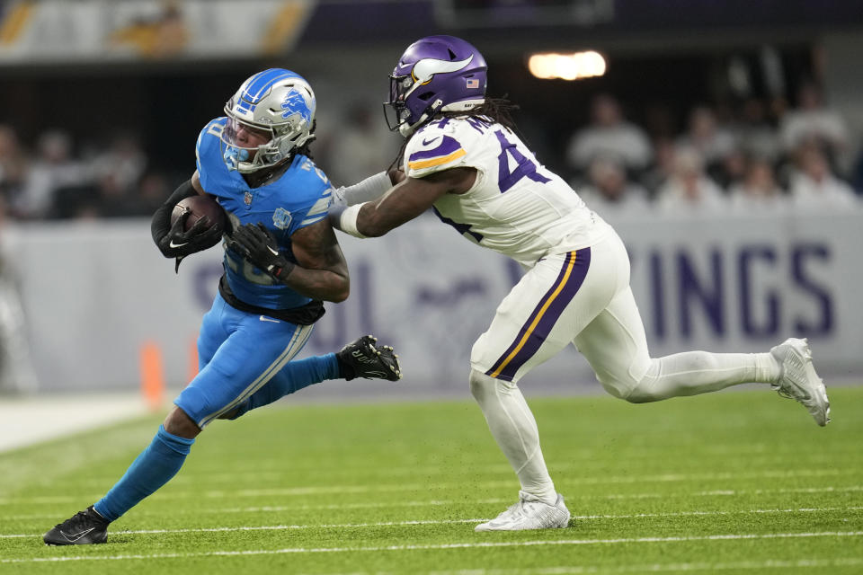 Detroit Lions running back Jahmyr Gibbs (26) runs from Minnesota Vikings safety Josh Metellus (44) during the second half of an NFL football game, Sunday, Dec. 24, 2023, in Minneapolis. (AP Photo/Abbie Parr)