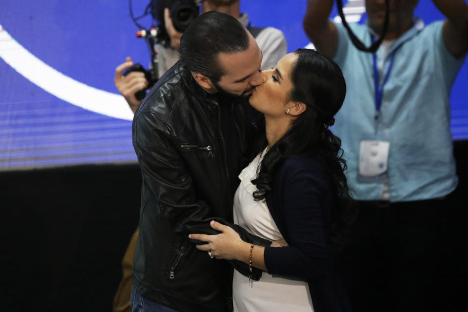 Presidential frontrunner Nayib Bukele, of the Grand Alliance for National Unity, kisses his wife Gabriela before giving a press conference, in San Salvador, El Salvador, Feb. 3, 2019. Bukele, a former mayor of El Salvador's capital, romped to victory in Sunday's presidential election, winning more votes than his two closest rivals combined to end a quarter century of two-party dominance in the crime-plagued Central America nation. (AP Photo/Moises Castillo)
