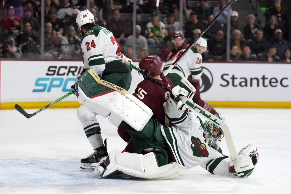 Minnesota Wild goaltender Marc-Andre Fleury gets knocked by Arizona Coyotes center Justin Kirkland (25) in the first period during an NHL hockey game, Thursday, March 7, 2024, in Tempe, Ariz. (AP Photo/Rick Scuteri)