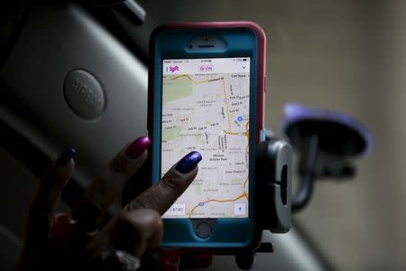 A Lyft driver from Sacramento, navigates a Lyft app on a smartphone during a photo opportunity in San Francisco, California February 3, 2016. REUTERS/Stephen Lam