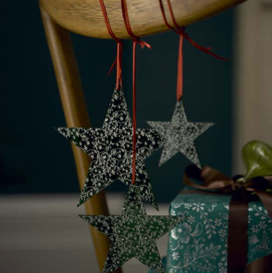 Dress your dinner chairs with ornaments. Just make sure not to hang breakable ones!