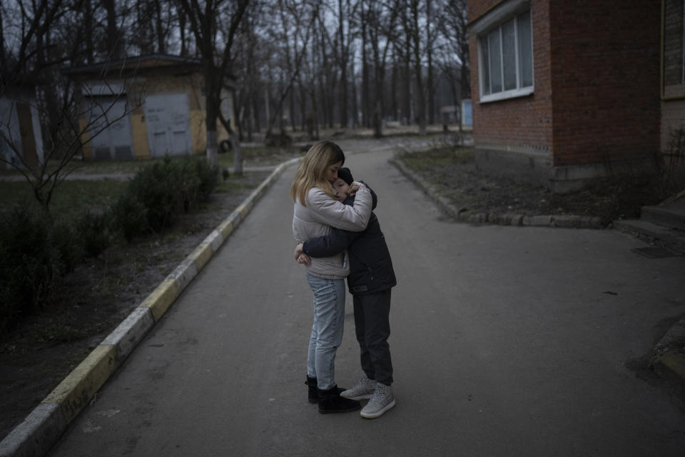 Anastasiia Okhrimenko hugs her son Vanya in Bucha, Ukraine, Friday, Jan. 24, 2023. As the conflict that killed their loved ones still rages on, Anastasiia and her son, Vanya wrestle with a question that all of war-torn Ukraine must grapple with: After loss, what comes next? (AP Photo/Daniel Cole)