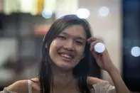 Lune Loh, 25, a transgender woman, poses for a portrait in Singapore, on Thursday, Aug. 18, 2022. She was raised as a boy by a protective mother and a conservative, stern father she grew to fear. Though he socialized Loh to be masculine, she knew early on that her body did not match who she was. Her first realization -- or flash point -- that something was off came one night at age 8, when she caught her distorted reflection in a window and suddenly imagined herself with long hair. (AP Photo/Wong Maye-E)