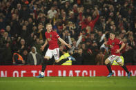 Manchester United's Scott McTominay, left, celebrates with Daniel James after scoring his side's second goal during the English Premier League soccer match between Manchester United and Manchester City at Old Trafford in Manchester, England, Sunday, March 8, 2020. (AP Photo/Dave Thompson)