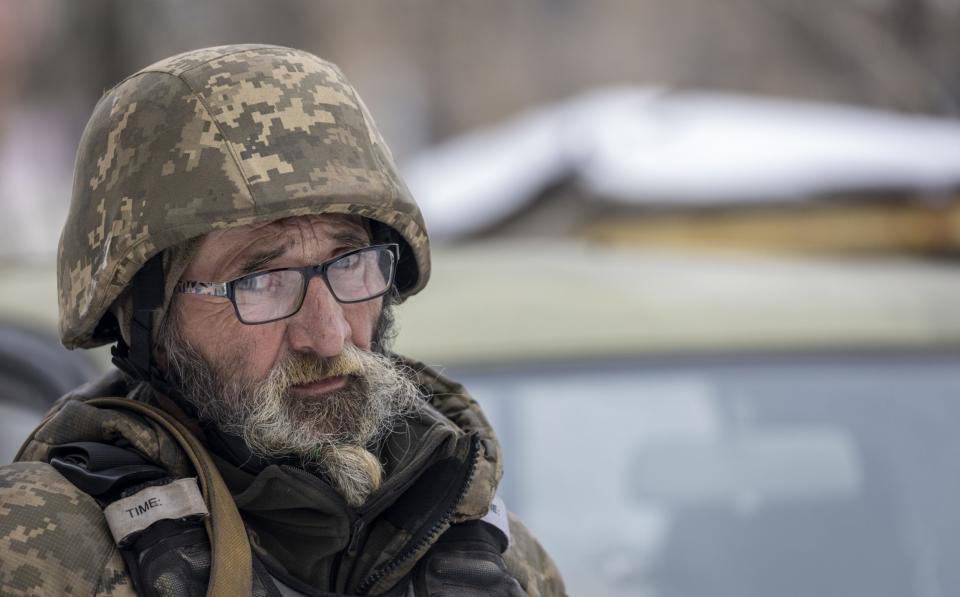 A Ukrainian soldier stands in a small encampment in freezing temperatures in Bakhmut - John Moore/Getty Images Europe