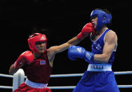 LONDON, ENGLAND - NOVEMBER 25: Declan Geraghty of Ireland (Blue) trades punches with Worapoj Petchkoom of Thailand during their quaterfinal, 56kg bout at ExCel on November 25, 2011 in London, England. (Photo by Jamie McDonald/Getty Images)