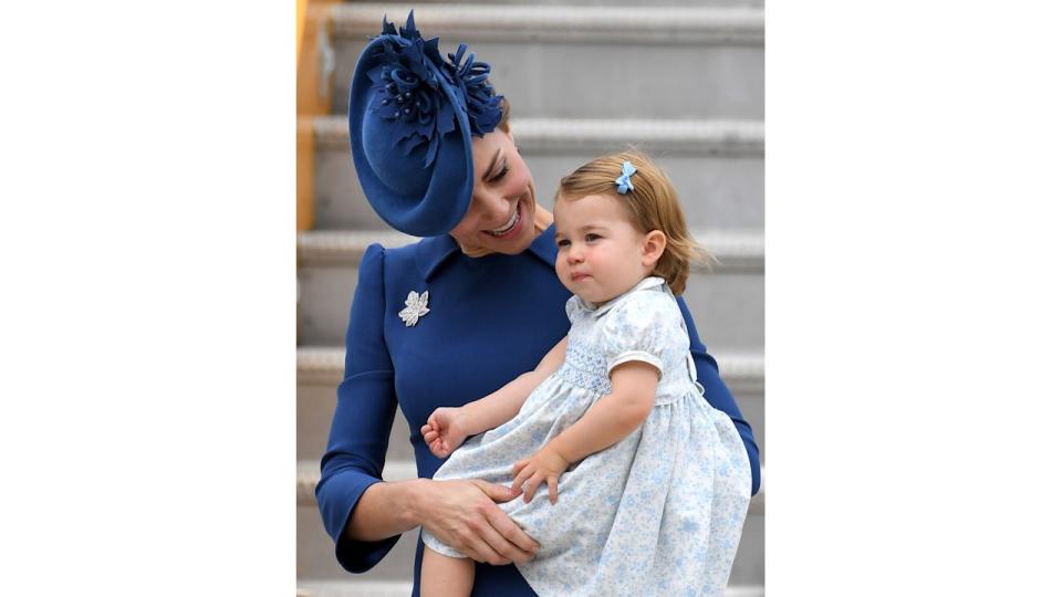 Princess Kate holding a baby Princess Charlotte