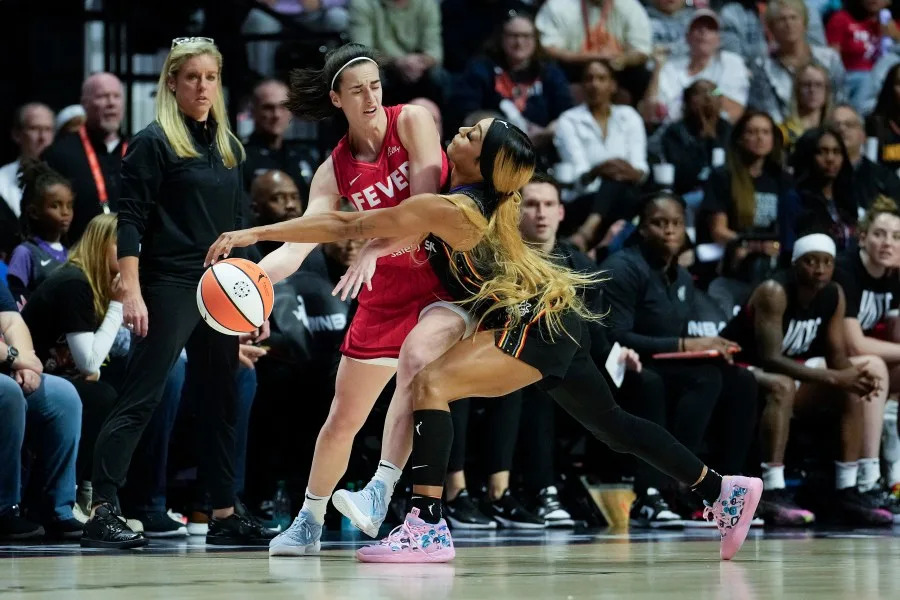 Caitlin Clark of the Indiana Fever looks to pass against DiJonai Carrington of the Connecticut Sun.