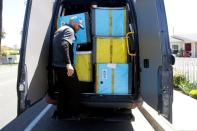 Joseph Alvarado steps down from the back of the van as he makes deliveries for Amazon during the outbreak of the coronavirus disease