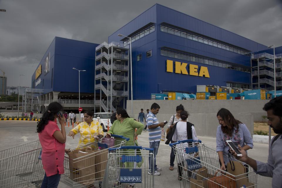 FILE- In this Aug. 9, 2018, file photo, Customers stand outside Ikea's first store in India as it opened in Hyderabad, India. India is a test case for whether Ikea should keep shifting resources toward emerging economies, including Latin America and China, given the saturation of markets in Europe and the United States, and the possibility of another global recession. Six months after Ikea opened its first store in Hyderabad, the 400,000-square-foot cornucopia of furniture, linens, kitchenware and other goodies is drawing between 10,000 and 30,000 visitors per day. (AP Photo/Mahesh Kumar A, File)