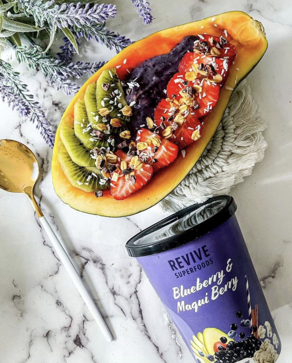 Revive Superfoods Smoothie Subscription with papaya and fruit inside on kitchen counter (Photo via @revivesuperfoods/Instagram)