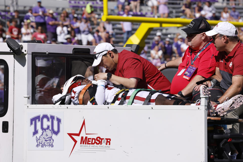 Oklahoma defensive back Damond Harmon (17) is tended to by team staff after a collision on a play against TCU during the second half of an NCAA college football game Saturday, Oct. 1, 2022, in Fort Worth, Texas. TCU won 55-24.(AP Photo/Ron Jenkins)