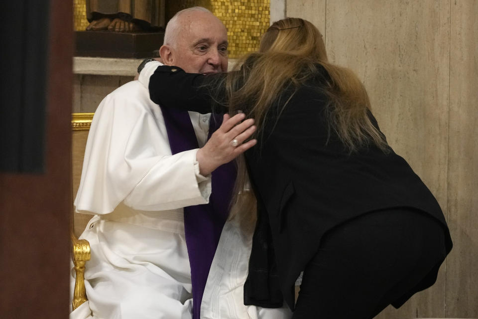 A woman hugs Pope Francis after confessing as he visits the parish church of St. Pius V for the "24 hours for the Lord" Lenten initiative of prayer and reconciliation, in Rome, Friday, March 8, 2024. The event will be celebrated in dioceses around the world on the eve of the fourth Sunday of Lent, from Friday 8 to Saturday 9 March.(AP Photo/Andrew Medichini)
