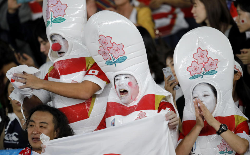 Fans celebrate after Japan defeated Scotland 28-21 in their Rugby World Cup Pool A game at International Stadium in Yokohama, Japan, Sunday, Oct. 13, 2019. (AP Photo/Christophe Ena)