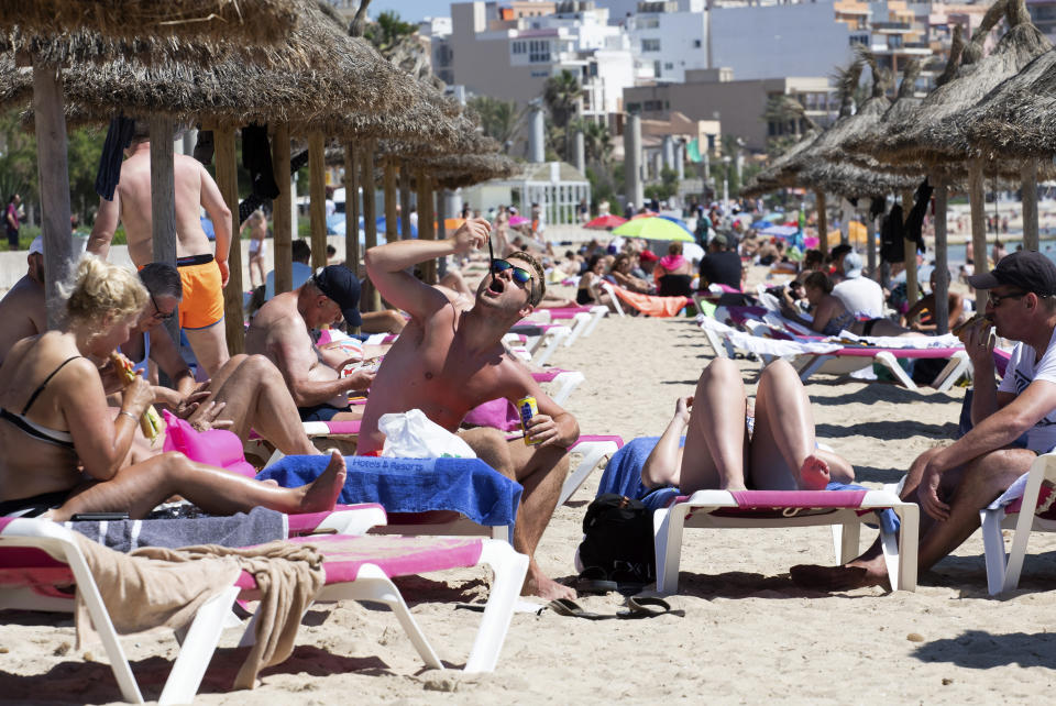 Tourists sunbathe on the beach at the Spanish Balearic Island of Mallorca, Spain, Monday, June 7, 2021. Spain is jumpstarting its summer tourism season by welcoming vaccinated visitors from most countries as well as European visitors who can prove they are not infected with coronavirus. It also reopened its ports to cruise ship stops on Monday. (AP Photo/Francisco Ubilla)