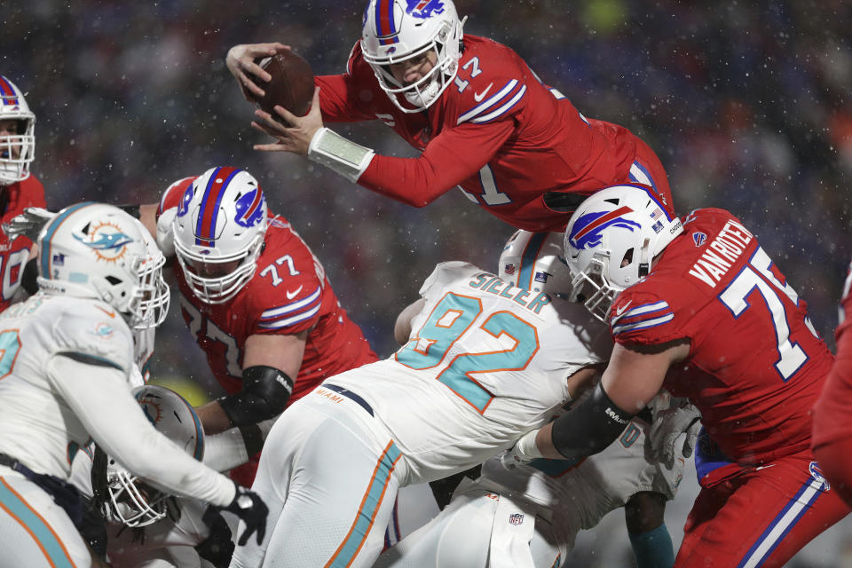 Buffalo Bills quarterback Josh Allen (17) dives for a two-point conversion during the second half of an NFL football game against the Miami Dolphins in Orchard Park, N.Y., Saturday, Dec. 17, 2022. (AP Photo/Joshua Bessex)