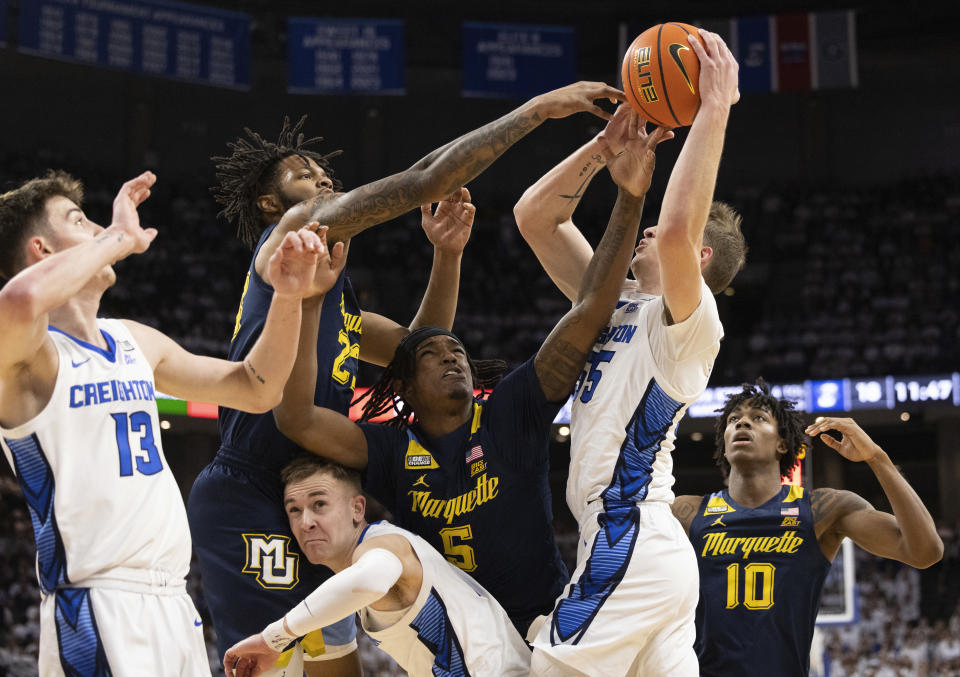 Marquette's David Joplin, second left, Tre Norman, center, and Zaide Lowery, right, reach for a rebound against Creighton's Mason Miller, left, Steven Ashworth, lower center, and Baylor Scheierman, second right, during the first half of an NCAA college basketball game Saturday, March 2, 2024, in Omaha, Neb. (AP Photo/Rebecca S. Gratz)