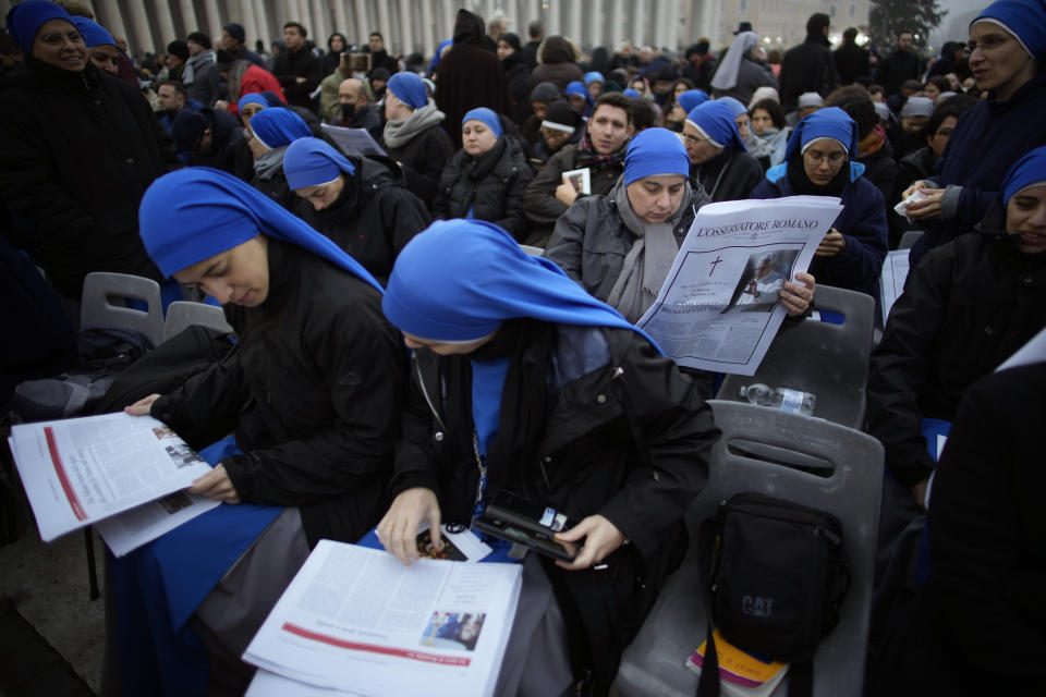 People occupy their positions at the St. Peter's Square at the Vatican ahead of the funeral mass for late Pope Emeritus Benedict XVI, Thursday, Jan. 5, 2023. Benedict died at 95 on Dec. 31 in the monastery on the Vatican grounds where he had spent nearly all of his decade in retirement, his days mainly devoted to prayer and reflection. (AP Photo/Domenico Stinellis)