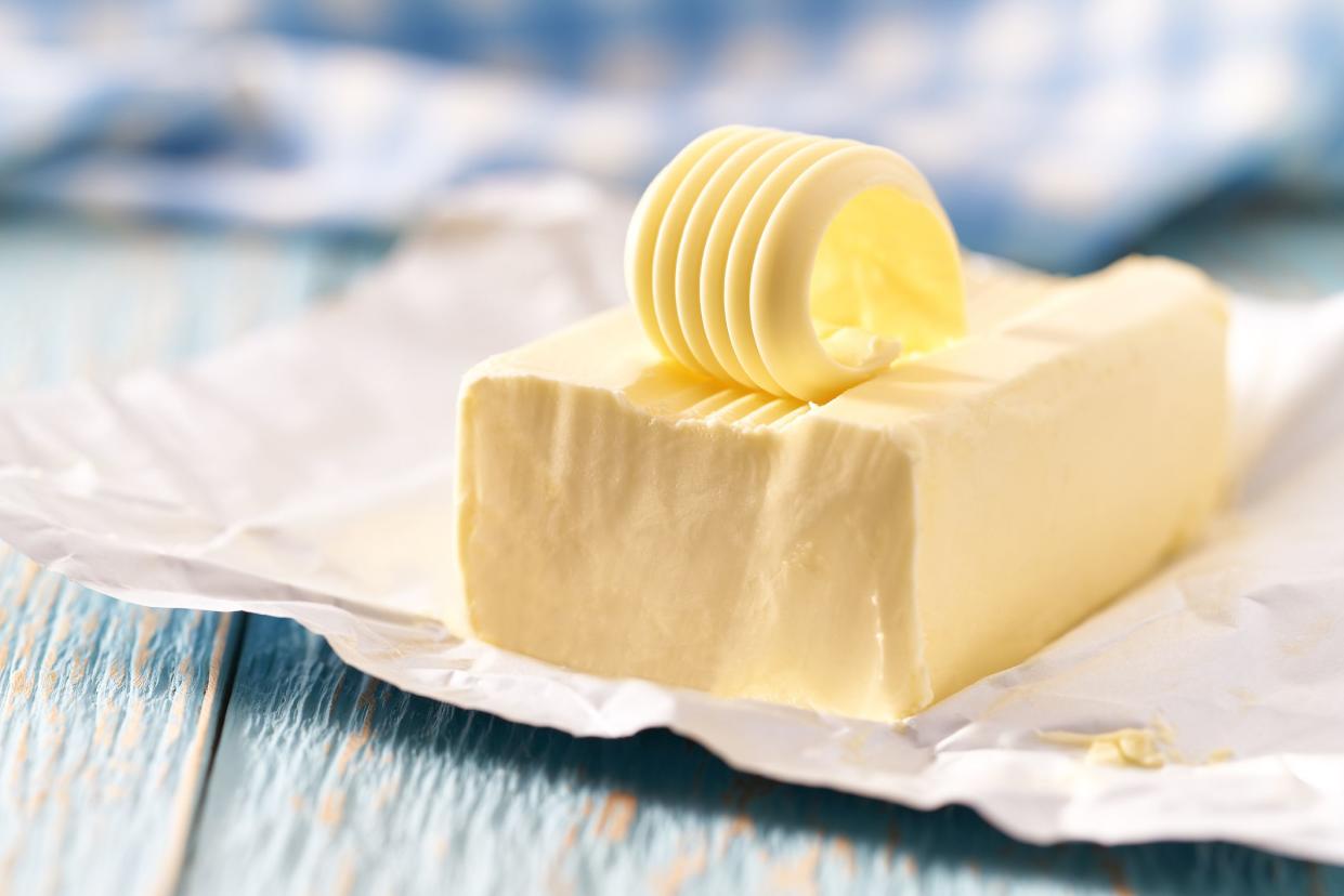 piece of butter on a blue wooden table, selective focus.