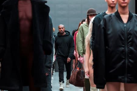 Singer Kanye West walks past models after presenting his Fall/Winter 2015 partnership line with Adidas at New York Fashion Week, U.S. February 12, 2015. REUTERS/Lucas Jackson/File photo