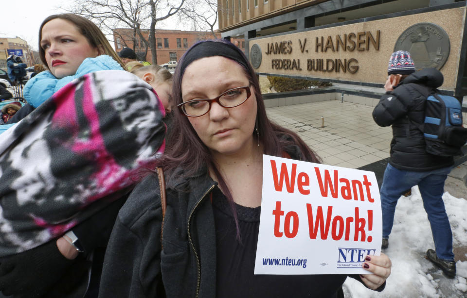 IRS worker Christine Helquist joins a federal workers protest rally outside the Federal Building, Thursday, Jan., 10, 2019, in Ogden, Utah. Payday will come Friday without any checks for about 800,000 federal employees affected by the government shutdown, forcing workers to scale back spending, cancel trips, apply for unemployment benefits and take out loans to stay afloat. (AP Photo/Rick Bowmer)