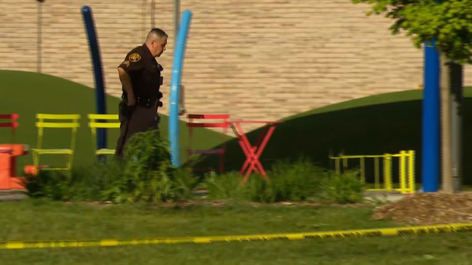 Police respond to the scene of a shooting Saturday at the Brooklands Plaza Splash Pad in Rochester Hills, Michigan. - WDIV