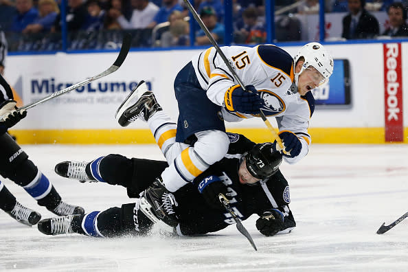 TAMPA, FL - APRIL 09: Tampa Bay Lightning left wing Adam Erne (73) slides into Buffalo Sabres center Jack Eichel (15) after losing his footing in the 2nd period of the NHL game between the Buffalo Sabres and Tampa Bay Lightning on April 09, 2017, at Amalie Arena in Tampa, FL. (Photo by Mark LoMoglio/Icon Sportswire via Getty Images)