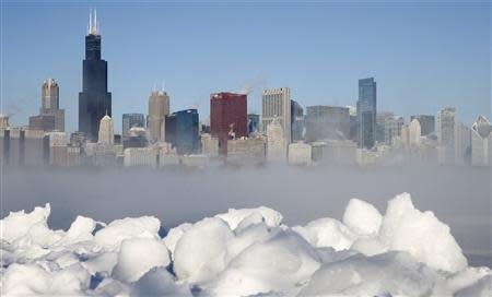 The Chicago skyline is seen beyond the arctic sea smoke rising off Lake Michigan in Chicago, Illinois, January 6, 2014. REUTERS/Jim Young