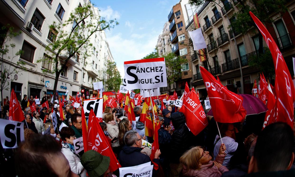 <span>A demonstrator holds up a sign reading 'Sánchez continues, yes' outside the PSOE headquarters in Madrid on Saturday.</span><span>Photograph: Rodrigo Jimenez/EPA</span>