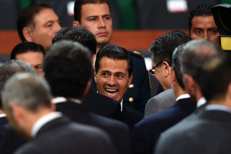 Mexican President Enrique Pena Nieto (C) gestures after delivering his third annual report at the National Palace in Mexico City on September 2, 2015