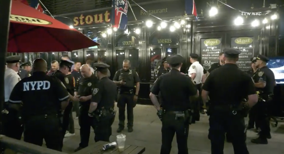 New York police stand outside Féile, on 3 June, 2022, where a man was stabbed in an apparently unprovoked knife attack. (Loudlabs NYC)