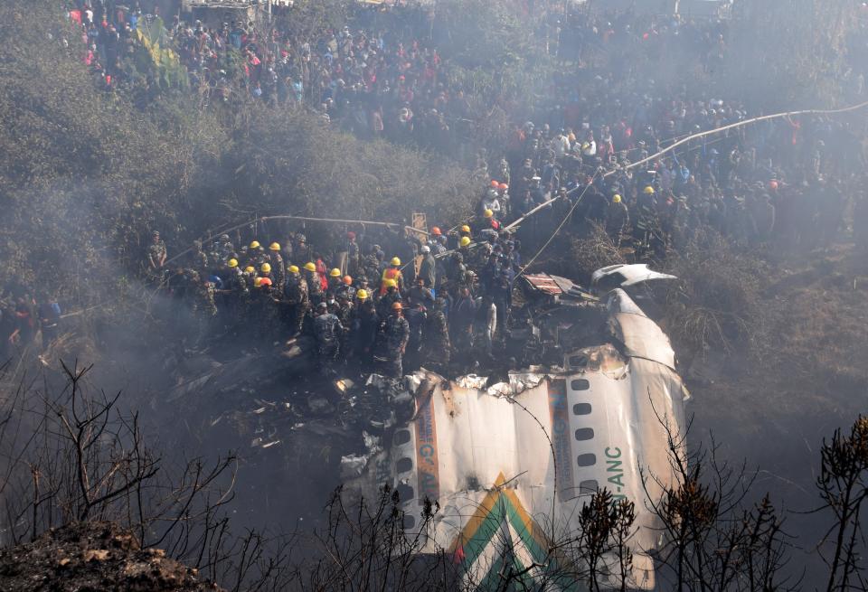 A general view of rescue teams working near the wreckage at the crash site of a Yeti Airlines ATR72 aircraft in Pokhara (EPA)