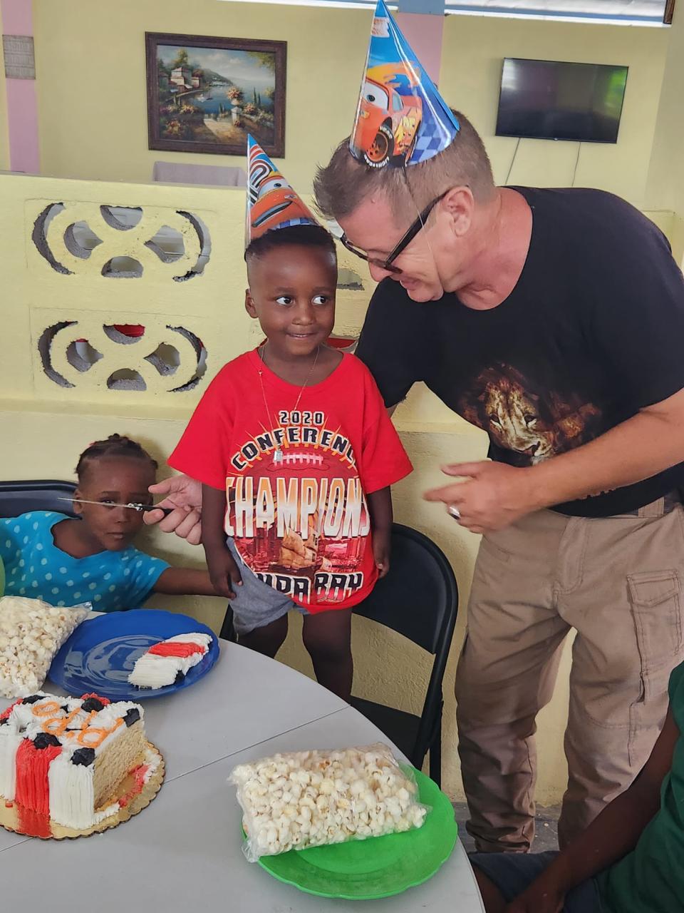 David Wine, a Polk County native, celebrates with children living in the Black and White for Jesus Ministries orphanage in Haiti. Wine, an ordained pastor, has operated the facility for about 10 years.