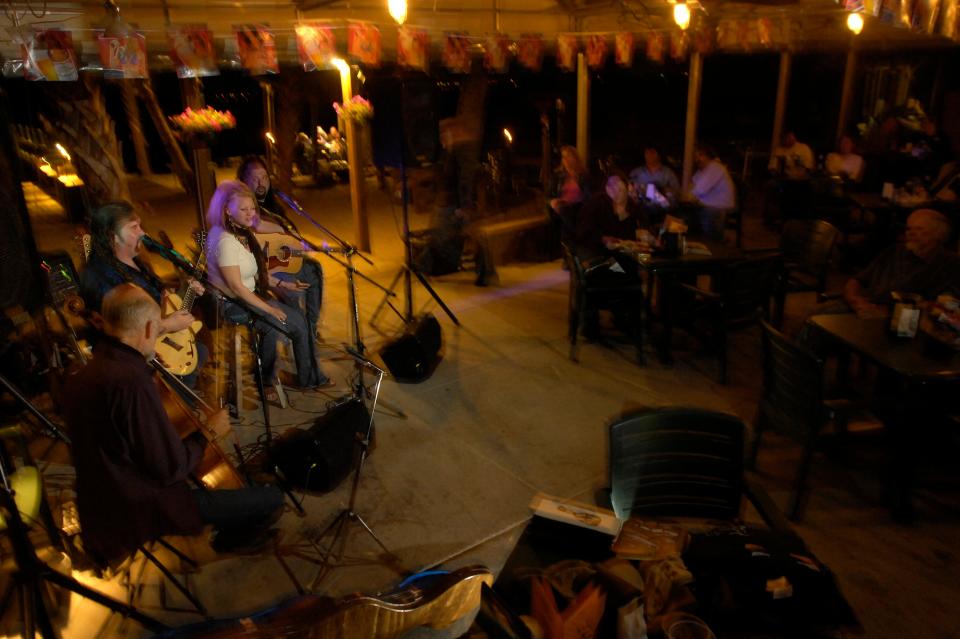 From left, Jeff Gilkinson, C.J. Watson, Camille and Chris Wallin perform Wednesday night at Paradise Bar & Grill for the Frank Brown Songwriters' Festival. The eleven day festival honors the late Frank Brown, a beloved and popular night watchman at the Flora-Bama Lounge who was usually the last person performers saw at closing time. 