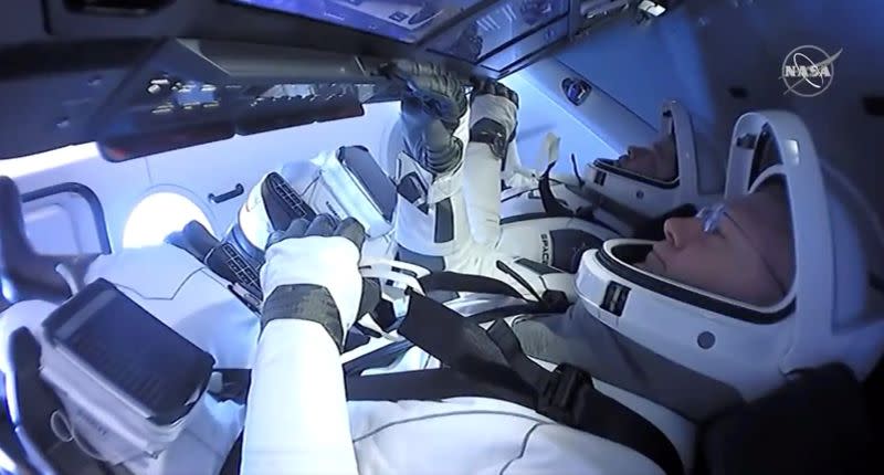 NASA astronauts Robert Behnken and Douglas Hurley are seen aboard SpaceX's Dragon Endeavour spacecraft