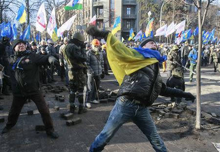 Anti-government protesters throw stones towards Interior Ministry officers during a rally near the building of Vekhovnaya Rada, Ukraine's house of parliament, in Kiev, February 18, 2014. REUTERS/Gleb Garanich