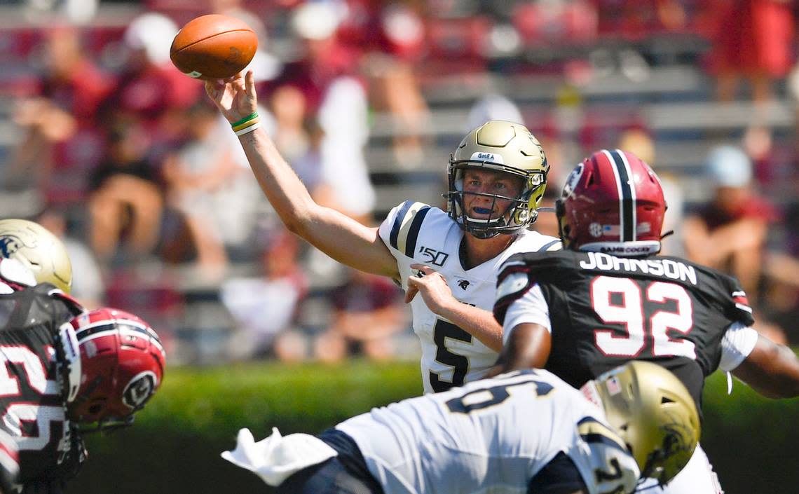 In this 2019 file photo, Charleston Southern quarterback Ross Malmgren (5) gets a pass of as South Carolina defensive lineman Tyreek Johnson (92) defends during a game in Sept. 2019, in Columbia, S.C.
