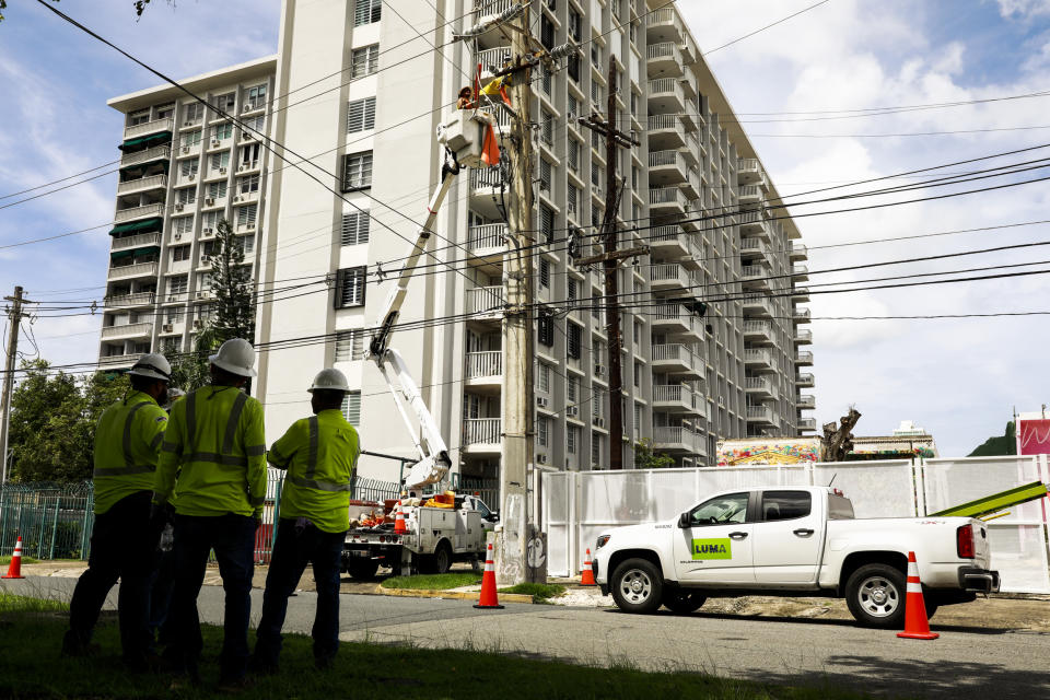 Image: Members of the company LUMA work restoring energy on Sept. 20, 2022 in San Juan, Puerto Rico. (Jose Jimenez / Getty Images)