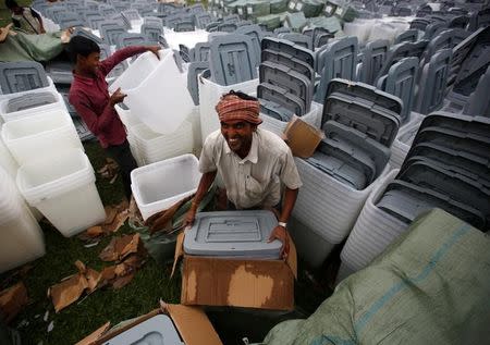 Men unload ballot boxes for the upcoming local election of municipalities and villages representatives at the election commission in Kathmandu, Nepal April 23, 2017. REUTERS/Navesh Chitrakar/Files