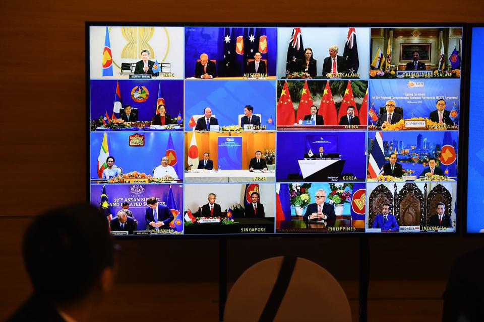 Representatives of signatory countries are pictured on screen during the signing ceremony for the Regional Comprehensive Economic Partnership (RCEP) trade pact at the ASEAN summit that is being held online in Hanoi on November 15, 2020. (Photo by Nhac NGUYEN / AFP) (Photo by NHAC NGUYEN/AFP via Getty Images)