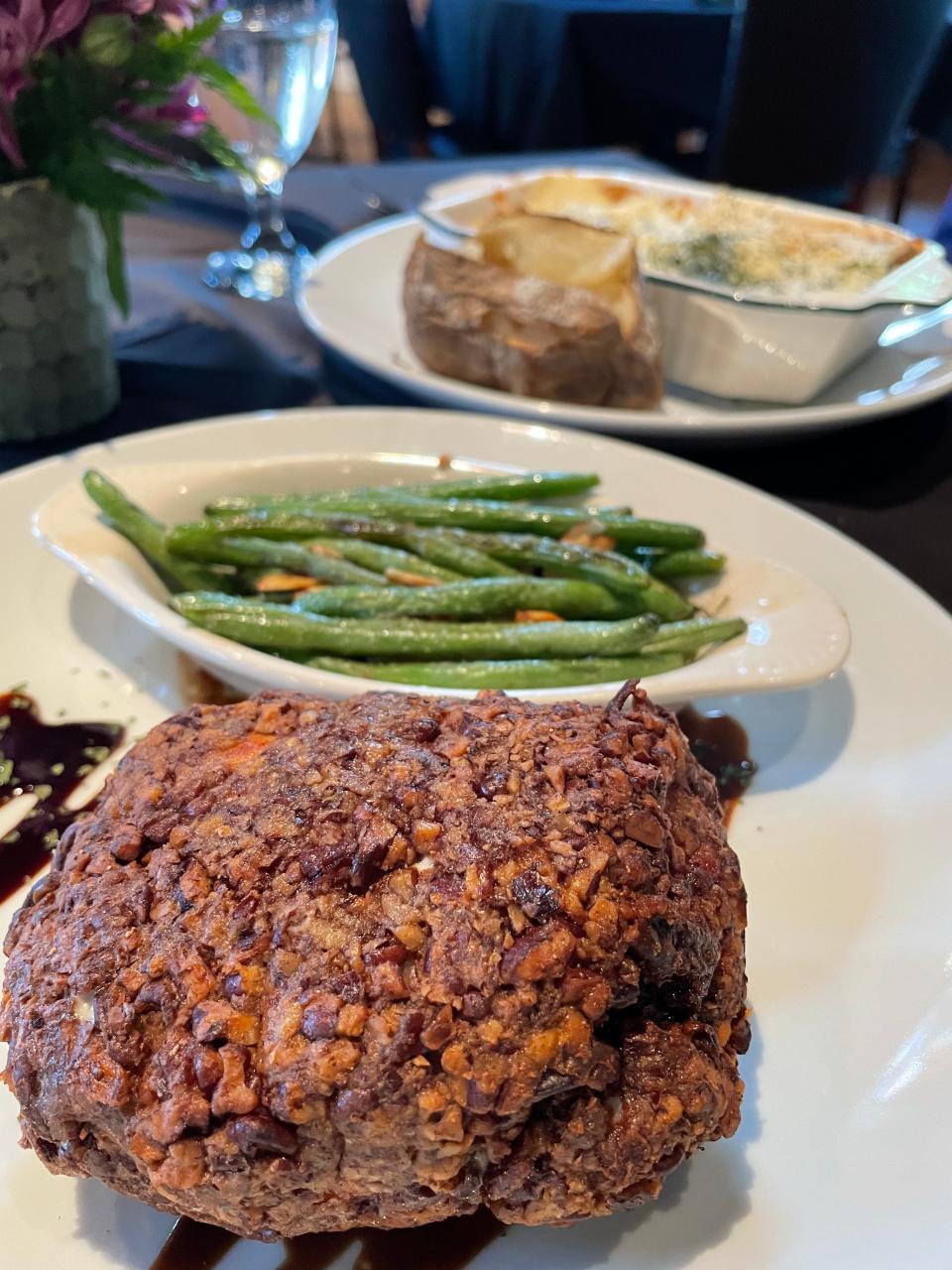 The stuffed pecan chicken breast at Thistle and Brier is stuffed with both goat cheese and Gouda and encrusted with chopped pecans and comes with two sides. Pictured here are the green beans almondine and a baked potato.