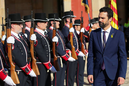 Roger Torrent, new Speaker of Catalan parliament, reviews Mossos d'Esquadra (Catalan regional police officers) in gala uniforms after the first session of Catalan parliament in Barcelona, Spain, January 17, 2018. REUTERS/Albert Gea